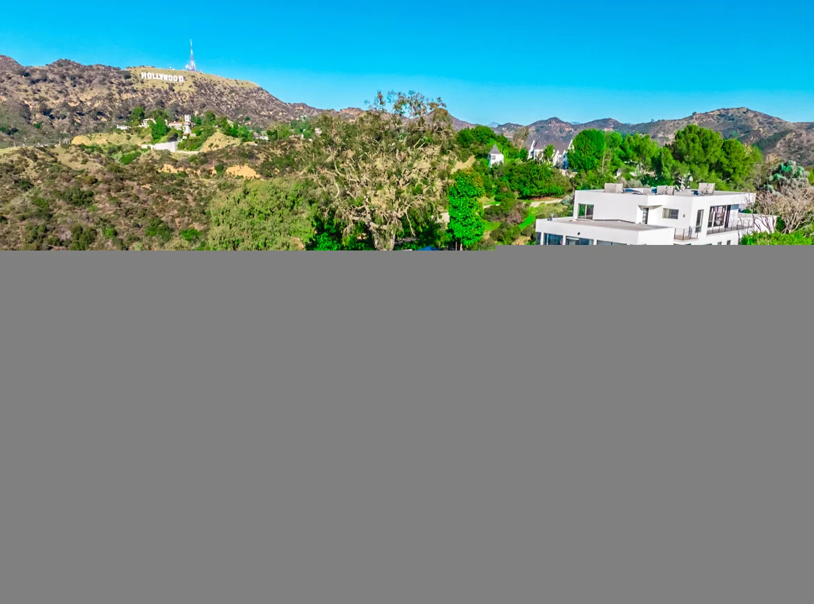 Bliss Recovery Luxury Rehab - bright living room with floor-to-ceiling windows and Hollywood Hills view
